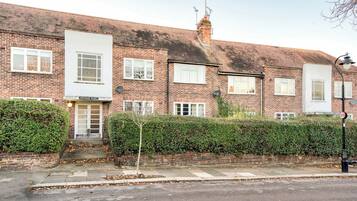 A row of terraced houses with a sign for "HOLYOKE COURT" on the front.