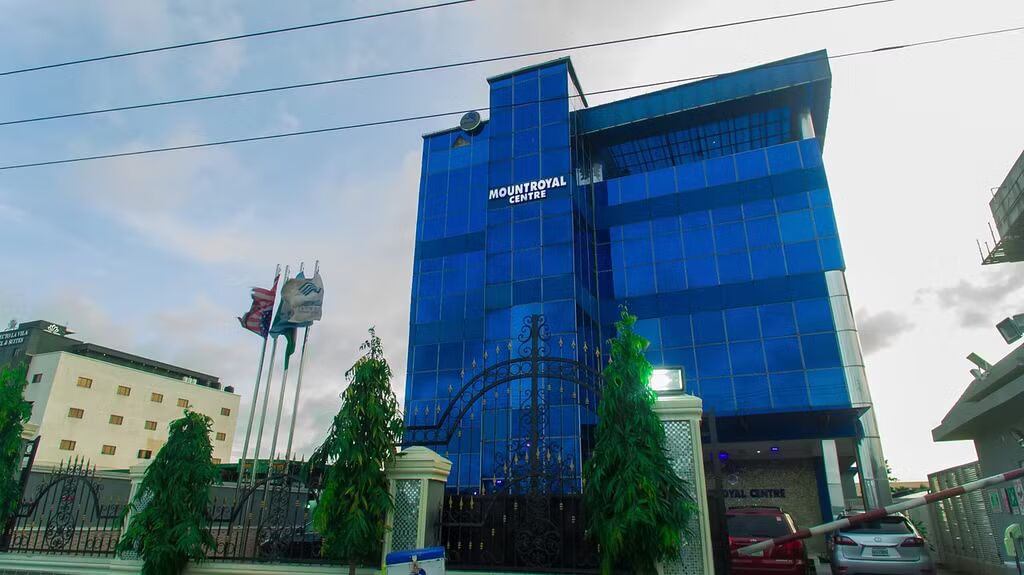 A modern building with a glass facade and the name 'MOUNTROYAL CENTRE' on the front.