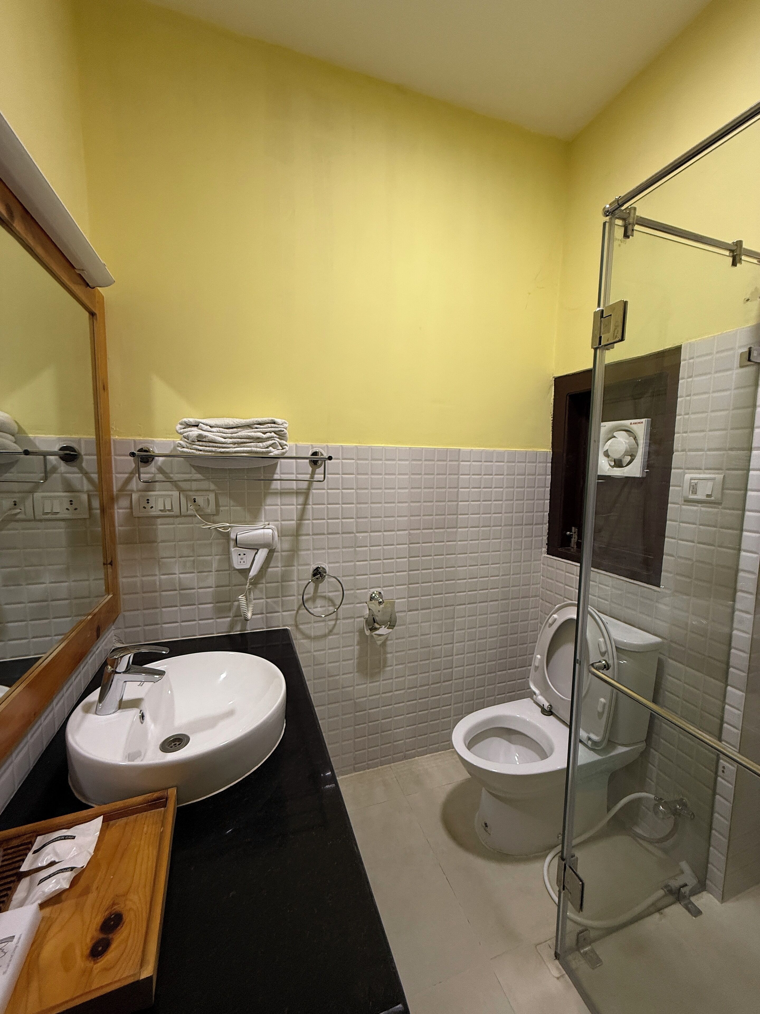 A bathroom with a sink, mirror, and toilet.