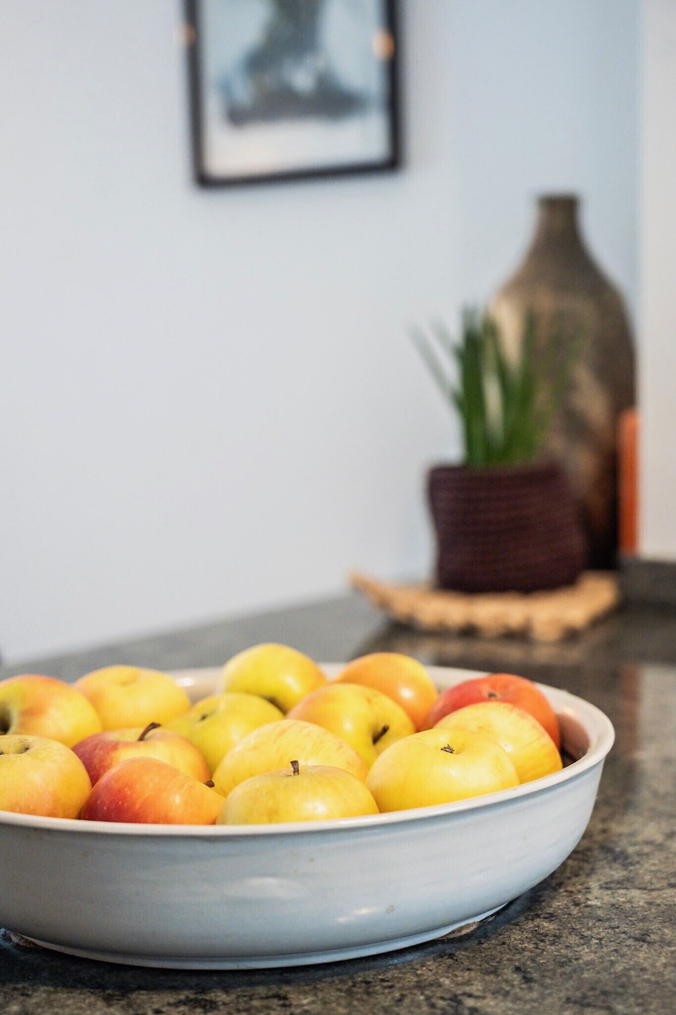 A bowl of apples on a kitchen counter.