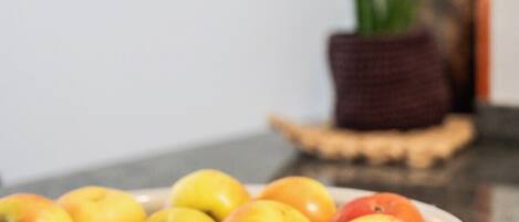A bowl of apples on a kitchen counter.