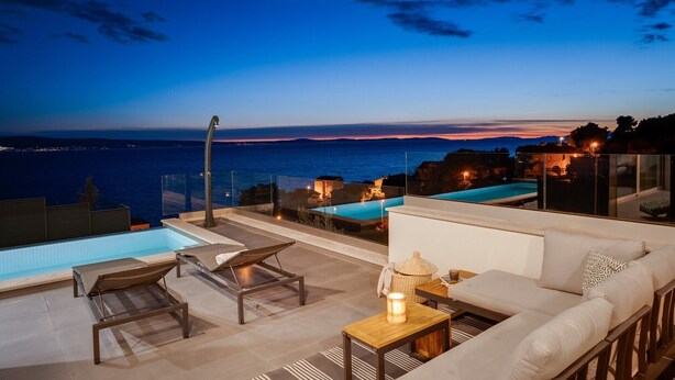 A rooftop terrace with a pool, lounge chairs, and a sofa overlooking a sunset view. - Villa Grey with 4 bedrooms, Heated pool, Sauna, Media room, Sea Views (Jesenice, Dugi Rat)