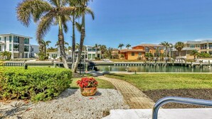 A resort with modern buildings, a swimming pool, and palm trees. - RENOVATED 4/3 Canal Front, Pool and Dock (Longboat Key)