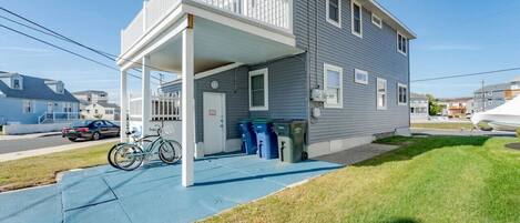 A two-story house with a covered porch and a bicycle parked outside.