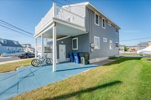 A two-story house with a covered porch and a bicycle parked outside.