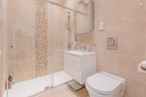 Apartamento básico | Banheiro | Chuveiro, toalhas de banho, sabonete, shampoo