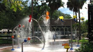 A water feature with multiple jets and colorful decorations in a park setting. - South Tampa! Stay Steps from Bayshore Near MacDill AFB (Tampa)