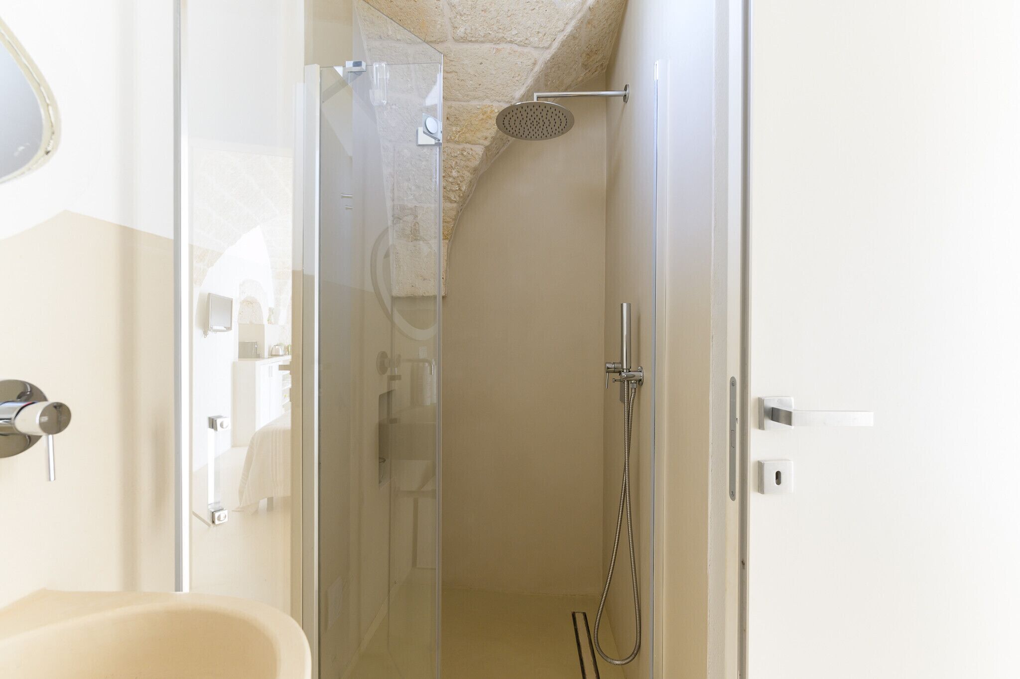 A modern bathroom with a glass shower enclosure, a bathtub, and a toilet.