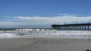 A pier extending into the ocean with a clear sky above. - Beaches and Birdies II -  First Floor Golf Resort Studio (Calabash)
