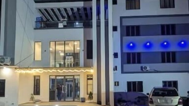 A modern building with a flat roof, large windows, and a paved entrance area. - Micasa-Sucasa Hotel and Suites (Port Harcourt)