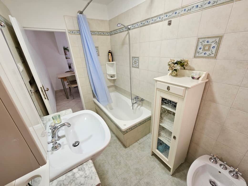 A bathroom with a sink, bathtub, and shower.