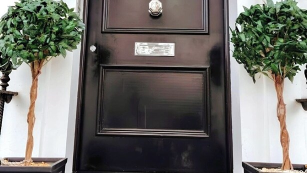 A black door with the number 111, flanked by two potted plants, and a CCTV warning sign above. - Notting Hill - The One One One! (3) (Greater London)