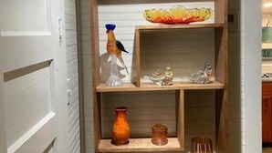 A wooden shelf with various decorative items including vases and figurines. - Breathtaking views amid a “PEACE” of heaven! (Fancy Gap)