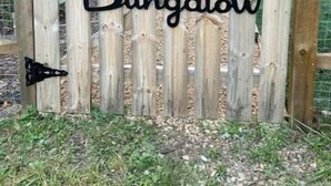 A wooden gate with the text "The Retro Bungalow" and an American flag. - Breathtaking views amid a “PEACE” of heaven! (Fancy Gap)