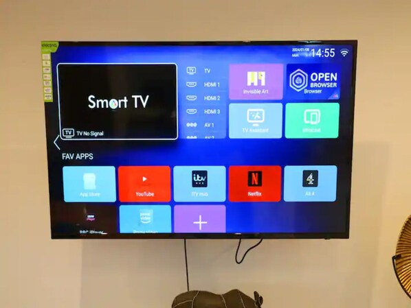 A TV screen displaying a smart TV interface with various apps and a "Smart TV" label.