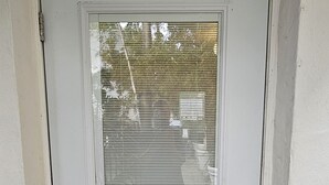 A white door with a number 1 above it, a keyhole, and a handle. - Sirena Azul SoBe Suite 1 (Miami Beach)