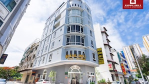 A multi-story hotel with a curved facade, large windows, and a prominent entrance. - Hotel Khánh Linh 2 (Ho Chi Minh City)