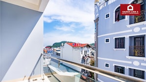 A hotel with a modern design, featuring balconies with glass railings and a view of the cityscape. - Hotel Khánh Linh 2 (Ho Chi Minh City)