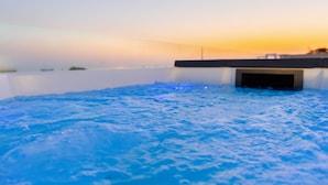 A hot tub with a view of the sunset.