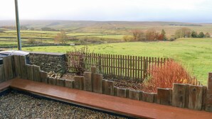 A view from a balcony with a wooden fence and a wooden deck. - The Byre (Hexham)
