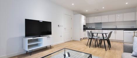 A modern apartment with a living area, dining space, and kitchen.