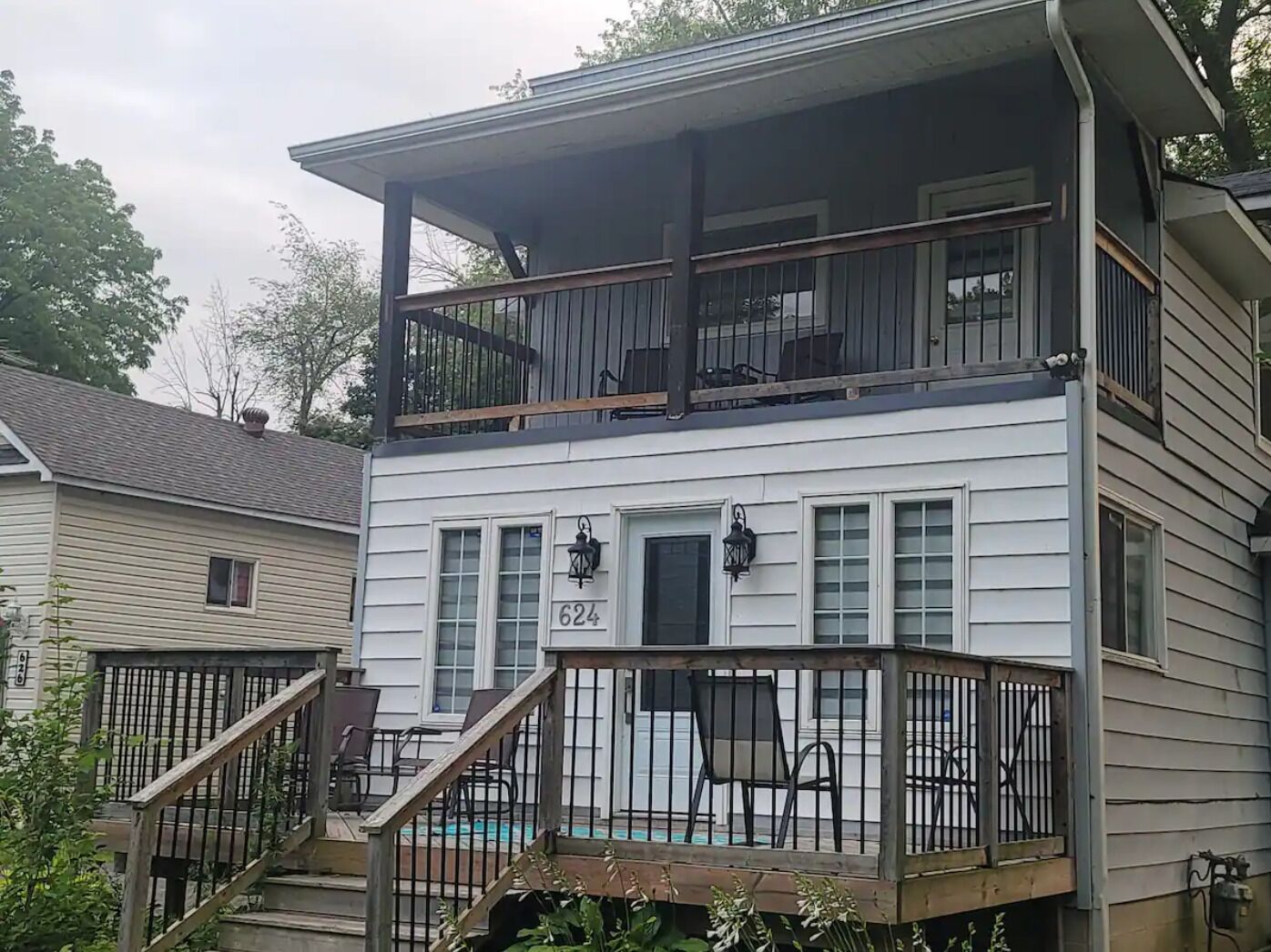 A two-story house with a balcony and a front porch.