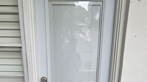 A white door with a number '3' above it, a doormat with 'WELCOME' written on it, and a metal gate to the left. - Sirena Azul SoBe Suite 3 (Miami Beach)