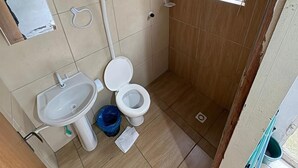 Un bany petit amb vàter, rentamig i plat de dutxa.