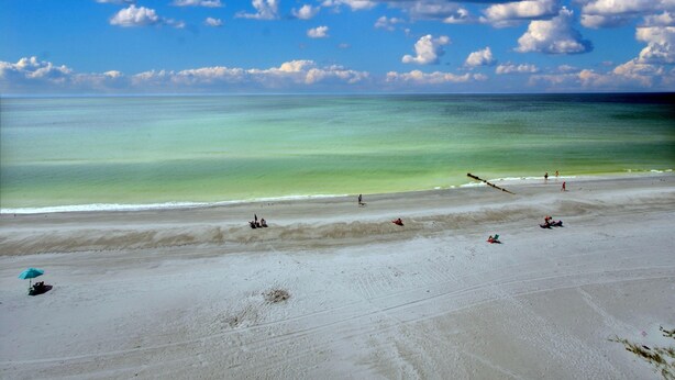 A beach with clear turquoise water and a sandy shore. - Arena De Madeira 502- Premier (Madeira Beach)