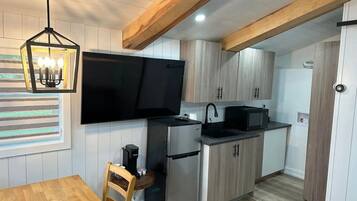 Fridge, microwave, coffee/tea maker, cookware/dishes/utensils