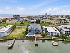 A coastal hotel with a pool, a dock, and a view of the beach and ocean. - Amadeus 3 (Treasure Island)