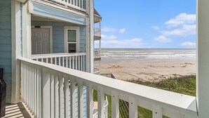 A coastal house with a balcony overlooking a beach. - Sandy Views - Step Right onto the Sand at Seascape Resort 2/2 condo (Galveston)