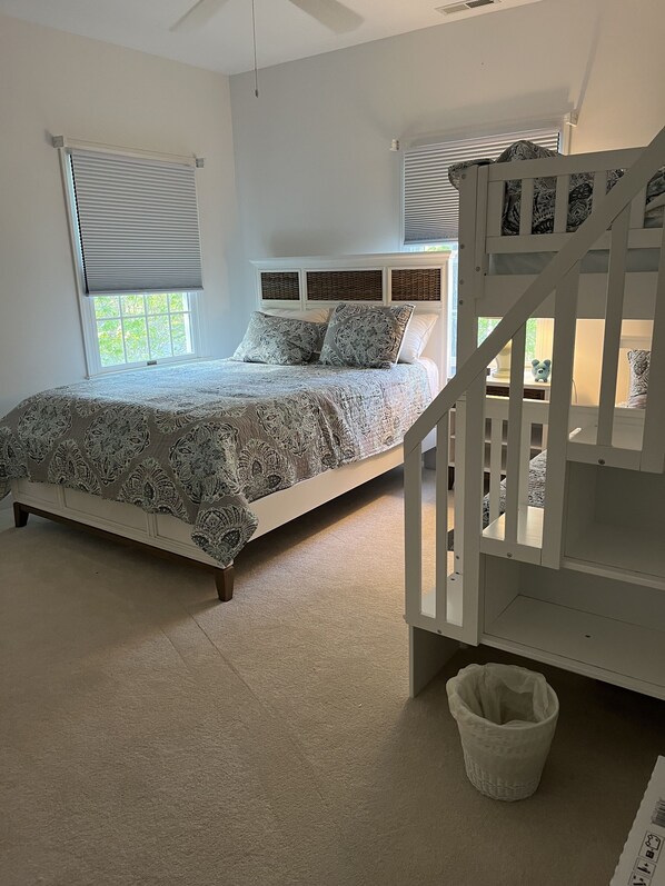 A bedroom with a bed, a crib, a window, and a ceiling fan. - Beautiful Bethany House in Salt Pond 1.5 miles from beach! All Seasons are nice! (Bethany Beach)