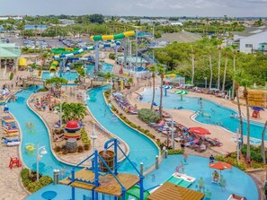 A water park with multiple pools, slides, and a large water slide.