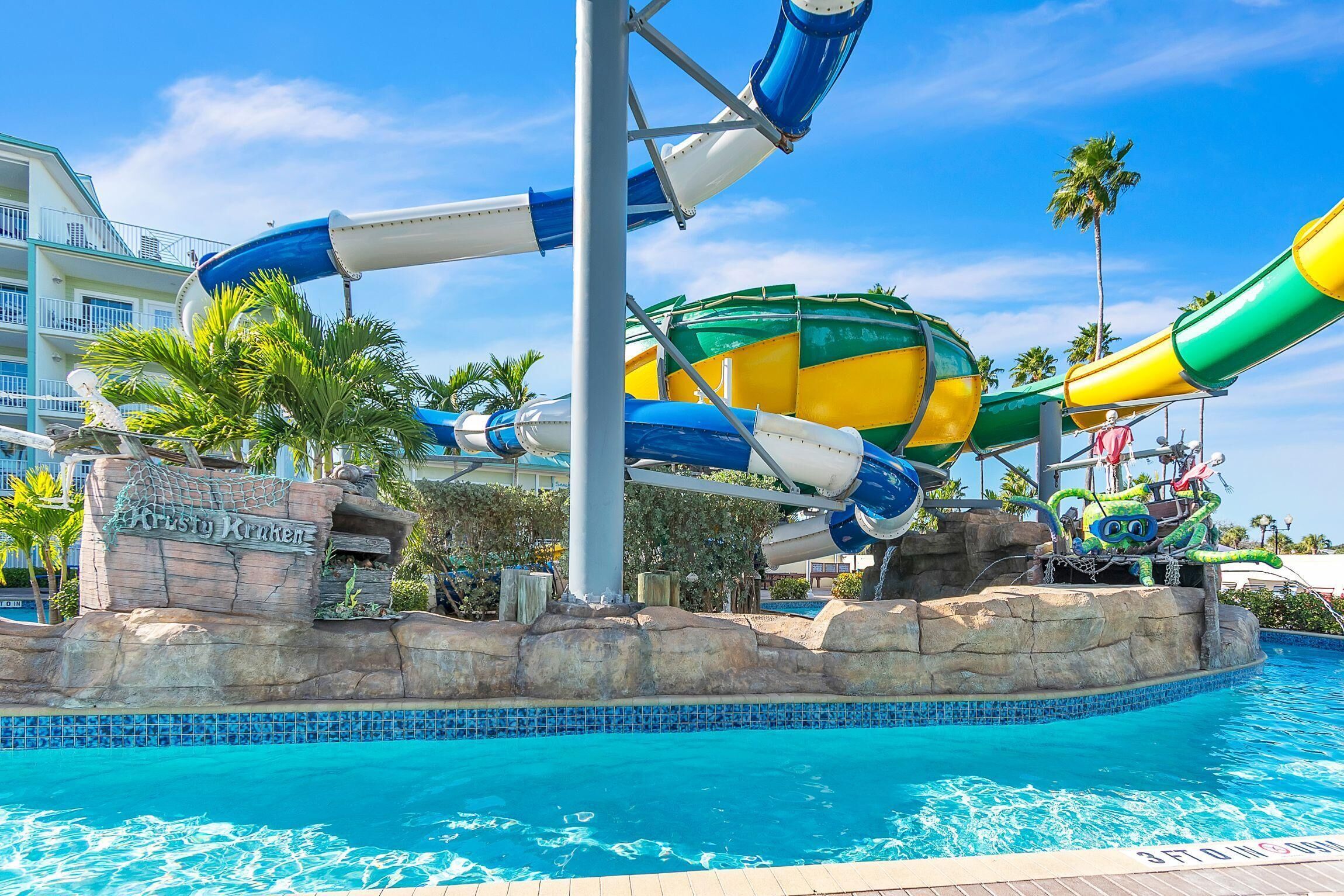 A water park with multiple slides and a pool.