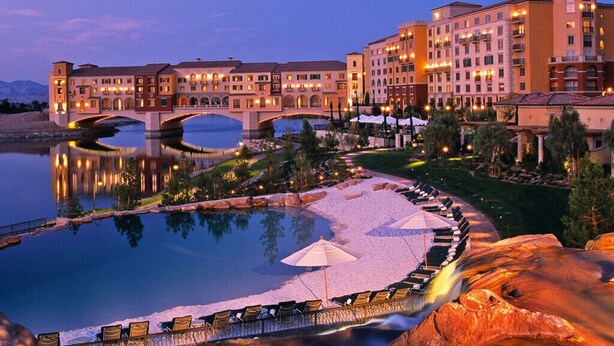 A hotel with a large pool, outdoor seating, and a bridge over water. - Exquisite, one of a kind place located in Lake Las Vegas Resort. Lovely decor  (Henderson)