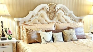 A bedroom with a large bed, ornate headboard, and decorative pillows. - Exquisite, one of a kind place located in Lake Las Vegas Resort. Lovely decor  (Henderson)