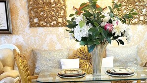 A luxurious room with ornate gold and white furniture, a glass-top table, and a chandelier. - Exquisite, one of a kind place located in Lake Las Vegas Resort. Lovely decor  (Henderson)