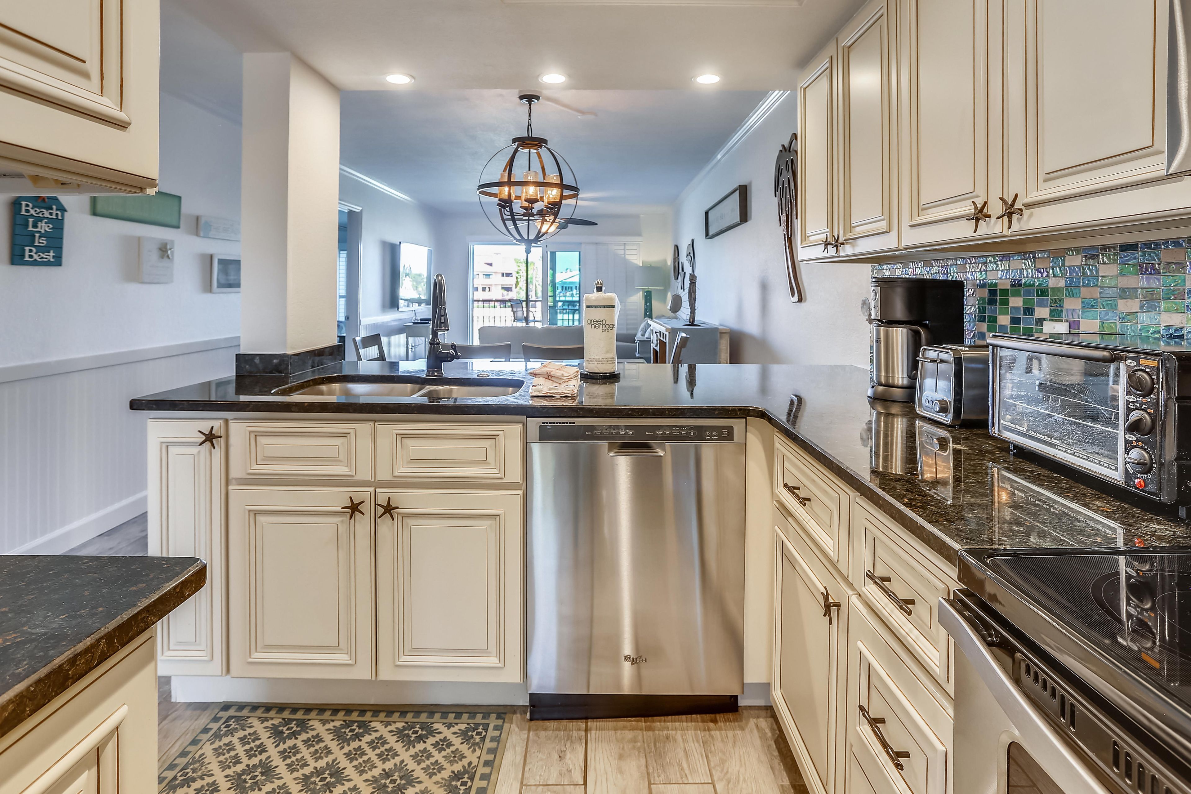 A modern kitchen with a dishwasher, stove, and toaster.