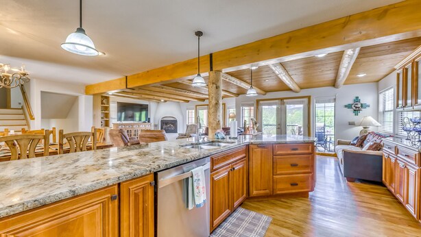A spacious kitchen with wooden cabinets, granite countertops, and a large island. - Scenic Alto Getaway w/ Mountain Views & Hot Tub! (Alto)