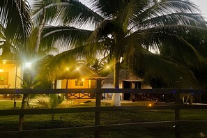 Experience the tranquil atmosphere of this tropical resort, surrounded by lush greenery and secure fencing.