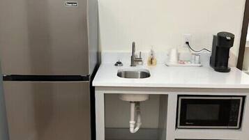 Fridge, microwave, coffee/tea maker, cookware/dishes/utensils