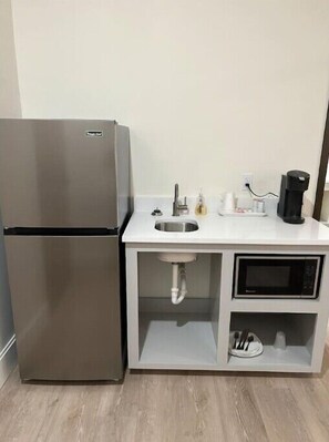 Fridge, microwave, coffee/tea maker, cookware/dishes/utensils