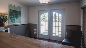 A hotel room with a large window, a map on the wall, and a ceiling light fixture. - Motel Park (Val-d'Or)