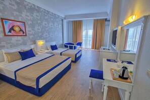A hotel room with two beds, a desk with a mirror, a television, and a window with curtains. - Seven Seas Palmeras Bay (Alanya)