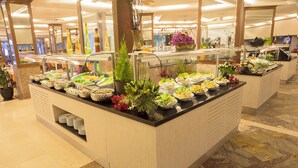 A buffet area with various food options and decorative plants. - Seven Seas Palmeras Bay (Alanya)