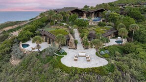 A luxurious resort with multiple pools, a central patio, and a scenic ocean view. - Oil Nut Bay (Virgin Gorda)