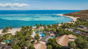 A resort with a large pool, beach, and ocean view. - Oil Nut Bay (Virgin Gorda)
