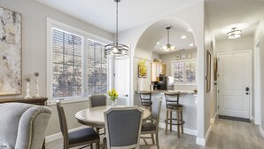 A dining area with a round table, six chairs, and a chandelier. - Inviting Cliffs Condo, AMAZING views, next 2 SILVER DOLLAR CITY, Table Rock Lake (Branson)