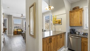 A kitchen with wooden cabinets, a granite countertop, and a dishwasher. - Inviting Cliffs Condo, AMAZING views, next 2 SILVER DOLLAR CITY, Table Rock Lake (Branson)